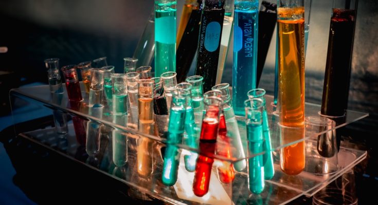 Colorful test tubes filled with liquids in a laboratory setting.