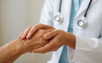 A caregiver holding the hand of an elderly person to show support and compassion