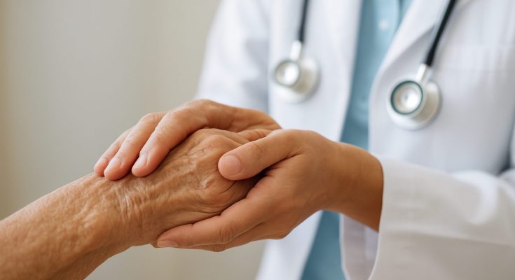 A caregiver holding the hand of an elderly person to show support and compassion
