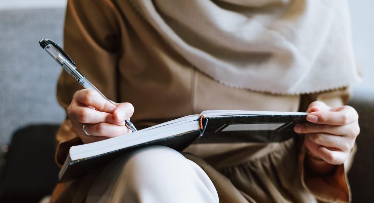 Muslim, woman, writing — Effortless Nangs Delivery to Your Doorstep