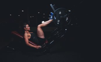 A woman engages in an intense leg press workout at the gym, showcasing strength and fitness. — Fitness Can Help To Eliminate
